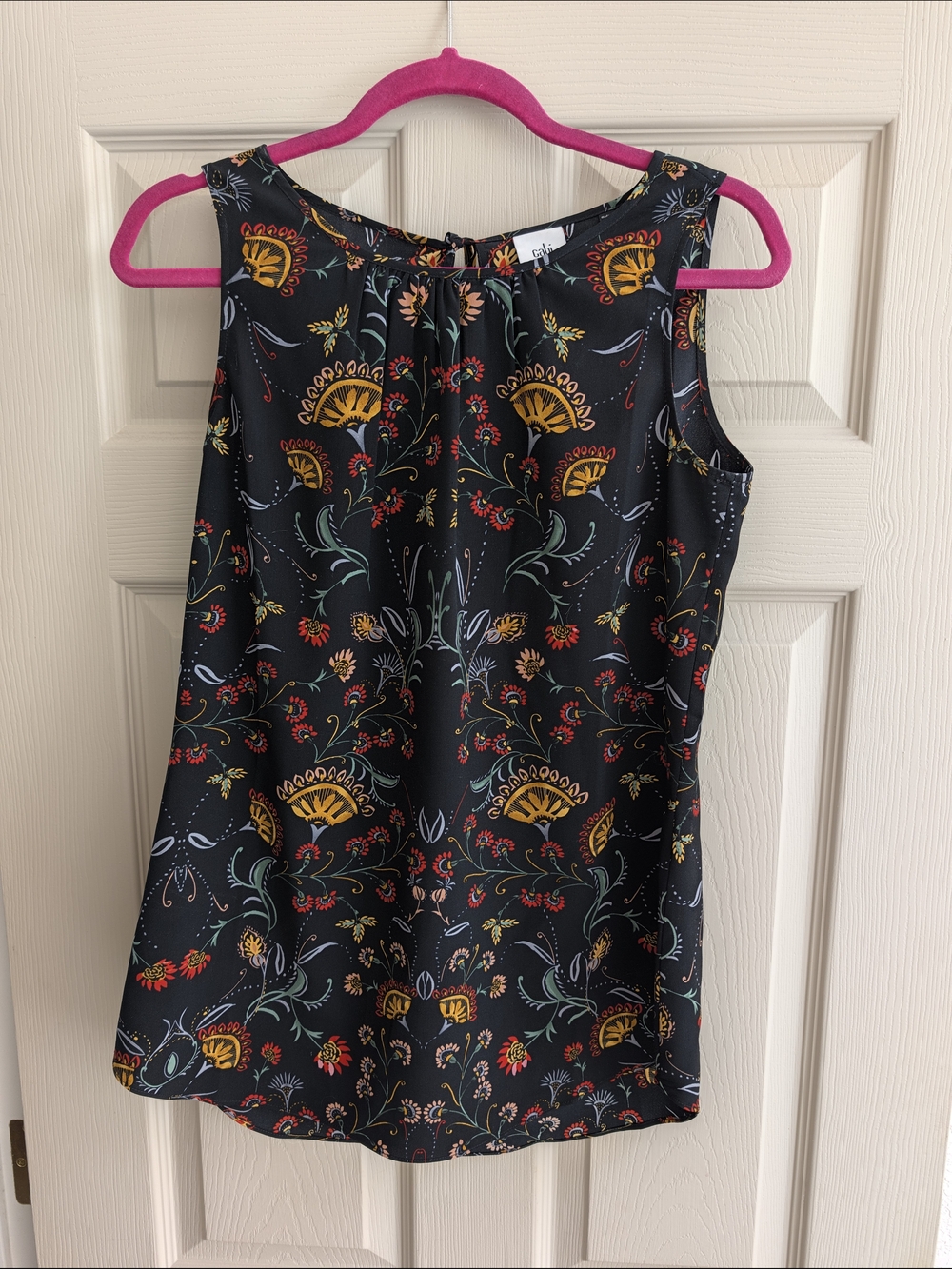 CAbi Black Floral Sleeveless Shell with Mustard and Teal Accents
